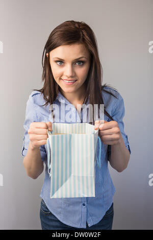 Cheerful pretty brunette receiving a present Stock Photo