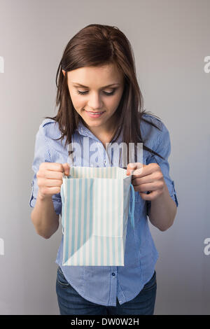 Smiling pretty brunette receiving a present Stock Photo