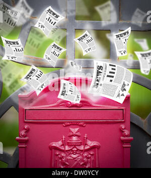 Post box with daily newspapers flying Stock Photo