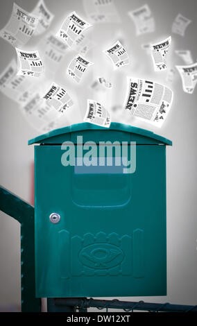 Post box with daily newspapers flying Stock Photo