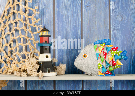 Stuffed colorful funny fish at home on blue wooden background Stock Photo