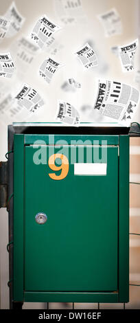 Post box with daily newspapers flying Stock Photo