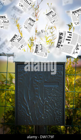 Post box with daily newspapers flying Stock Photo