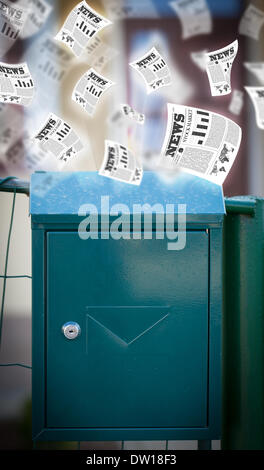 Post box with daily newspapers flying Stock Photo