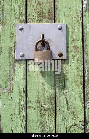 Old key lock on wooden door Stock Photo