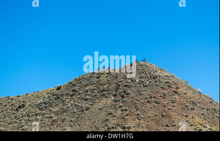 Young mountain bikers ride along a ridge in the Arkansas River Valley hills above Salida, Colorado, USA Stock Photo