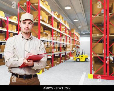 delivery man in warehouse Stock Photo