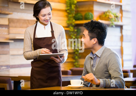 Customer using digital tablet for ordering Stock Photo