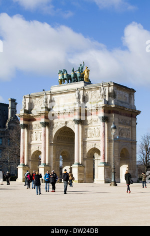 Tourists wandering around the Arc de Triomphe du Carrousel opposite the entrance to the Louvre Stock Photo