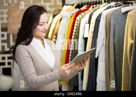 Clothing store owner with digital tablet Stock Photo