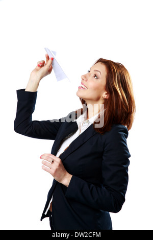 Happy businesswoman throwing paper plane isolated on a white background Stock Photo