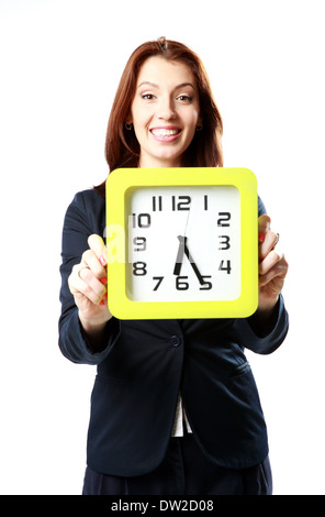 Cheerful businesswoman holding wall clock isolated on white background Stock Photo