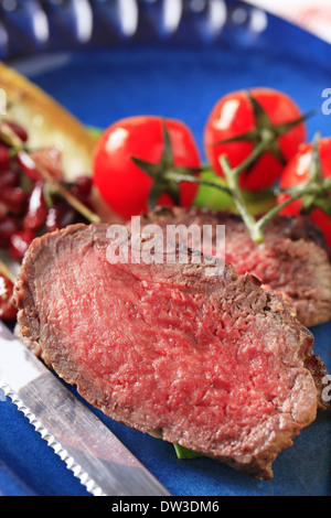 Slices of roast beef with vegetable garnish Stock Photo