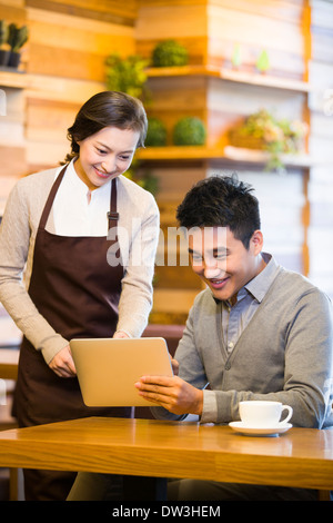 Customer using digital tablet for ordering Stock Photo