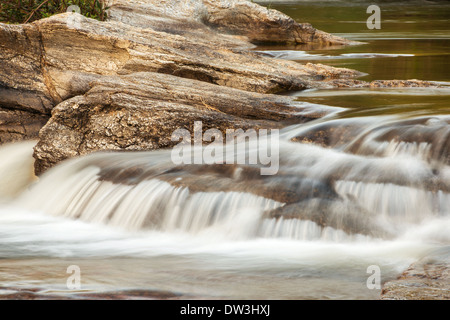 Water stream running over the rocks in the forest Stock Photo