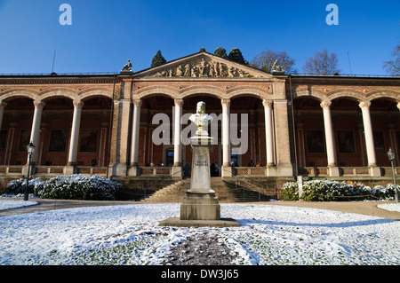 A bust of Kaiser Wilhelm the First in front of the Trinkhalle, or pump house, in Baden-Baden, southern Germany. December. Stock Photo