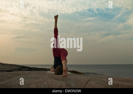 Iyengar Yoga Instructor Demonstrates Sarvangasana Ekapada (Inverted). Stock Photo