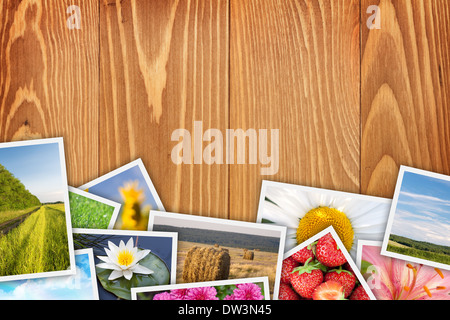 Stack of printed pictures collage on wooden table with copy space for your text or photo Stock Photo
