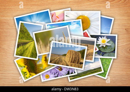 Stack of printed pictures collage on wooden table Stock Photo
