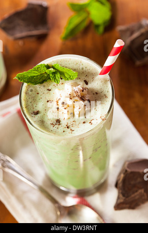 Cold Refreshing Mint Chocolate Chip MilkShake with a Straw Stock Photo