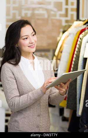 Clothing store owner with digital tablet Stock Photo