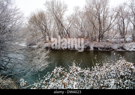 Snow and ice on the Arkansas RIver which runs through the downtown historic district of the small town of Salida, Colorado, USA Stock Photo