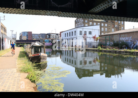 Cycling along the towpath of the River Lee Navigation at trendy Hackney Wick, East London, UK Stock Photo