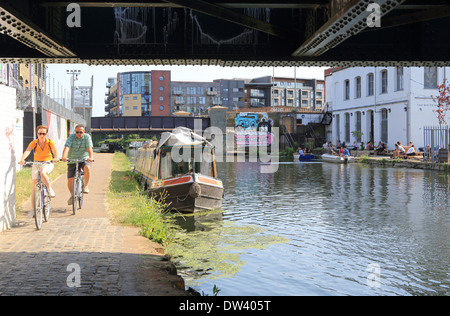 Cycling along the towpath of the River Lee Navigation at trendy Hackney Wick, East London, UK Stock Photo