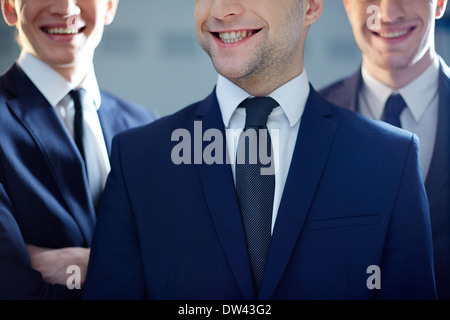 Cropped image of a ceo grinning from ear to ear being on the foreground Stock Photo