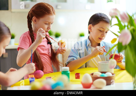 Cute preschoolers painting eggs for Easter Stock Photo