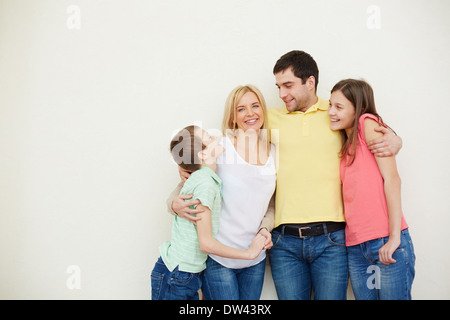 Portrait of affectionate family of four in isolation Stock Photo