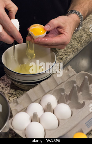 Separating egg white from yolk Stock Photo