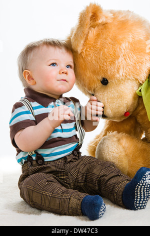 Baby boy, 16 Months old wearing striped shirt and suspenders, white background Stock Photo