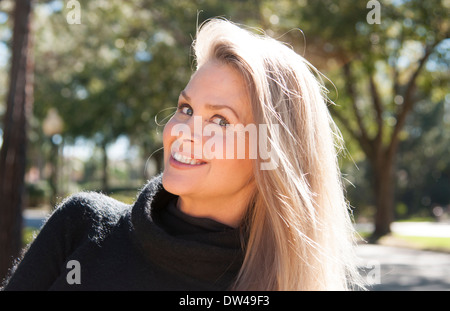 Testimonial of young attractive 50 year old woman smiling outdoors still beautiful even in middle age Stock Photo