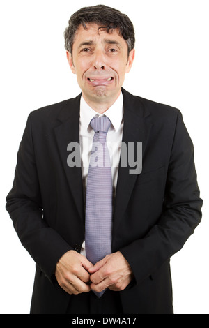 Isolated portrait of a middle-aged businessman standing crying through loss and grief or because of failure Stock Photo