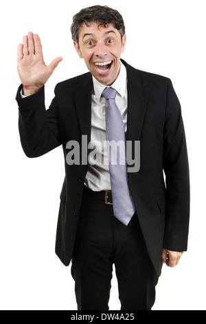 Quirky businessman with an animated expression and mouth open waving hello with the palm of his hand isolated on white Stock Photo