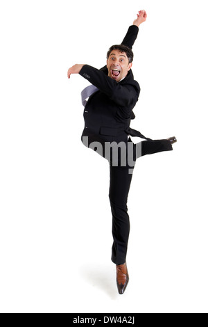 Fun portrait of an excited agile businessman in smart shoes and a suit performing ballet doing a pirouette, isolated on white Stock Photo