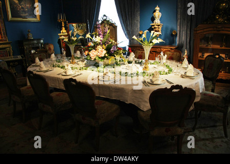 Victorian dining table setting, silver service place settings in a dining room Stock Photo