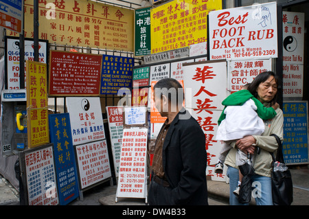 Street corner with Chinese advertising boards, Chinatown, Lower East Side, New York City, USA. The Chinatown neighborhood Stock Photo
