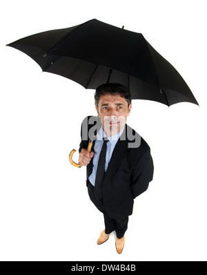 High angle full length portrait of an attractive dapper businessman sheltering under a large black umbrella looking up