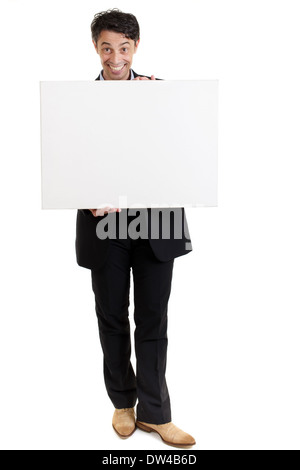 Persuasive middle-aged man with a big smile holding a blank sign in front of his chest . Stock Photo