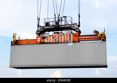 Sea container lifted by a harbor crane Stock Photo