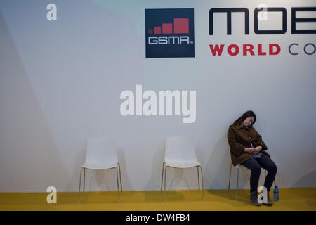 Barcelona, Spain. 27th Feb, 2014. MWC attendee resting at the fairgrounds hosting the convention.  Mobile World Congress held in Barcelona arrives at its last day after four journeys of intense activity  at the major event of mobile technology in the world. Credit:   Jordi Boixareu/Alamy Live News Stock Photo