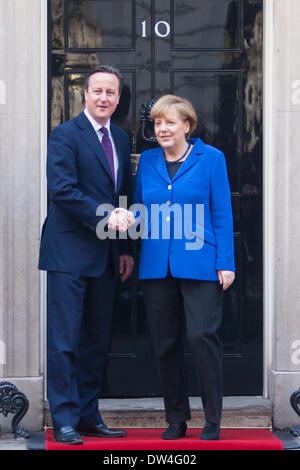 London, UK. 27th February 2014. British Prime Minister  David Cameron greets German Chancellor Angela Merkel as she arrives at Downing Street for a working lunch following her meeting at Parliament. Credit:  Paul Davey/Alamy Live News Stock Photo