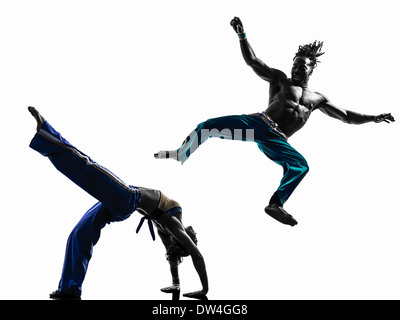 two people couple capoeira dancers dancing in silhouette studio isolated on white background Stock Photo