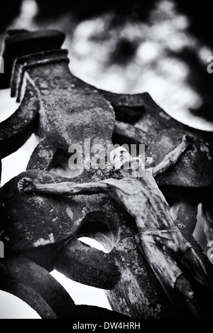 Statue of Jesus christ on a grave stone. Monochrome Stock Photo