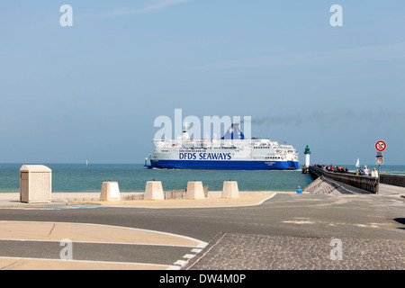 Ferry departing the harbour of Calais, France. It is a sunny morning and a lot of people on the pier. Stock Photo