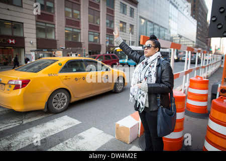 Manhattan New York city in North America, Pictured a hailing a cab on 8th Avenue Stock Photo