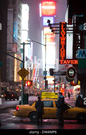 Pedestrians wait at a traffic light as an advertisement for the Samsung ...