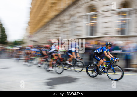 a NetApp team rider leads the peloton in the 2013 Tour of Britain final stage race around the streets of London, England UK Stock Photo